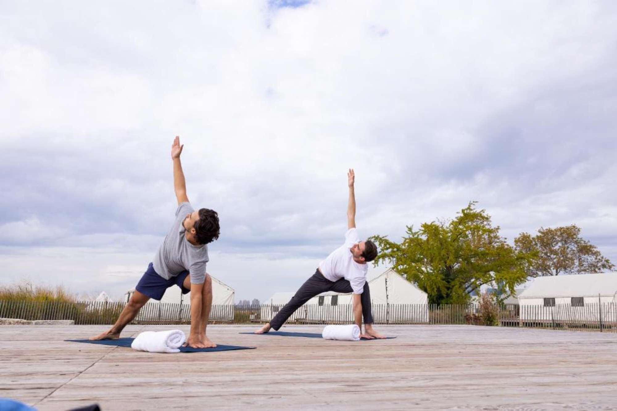 Morning yoga session near glamping tents and open sky