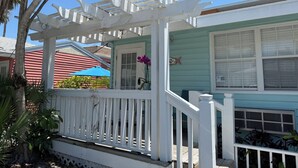 A house with a porch, a door, and a window.