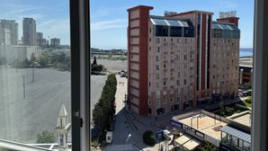 A high-rise building with a modern design, featuring a mix of glass and brick facades. - Pin Suite (Istanbul)
