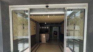 A reception area with a reception desk, clocks, and a patterned ceiling. - Pin Suite (Istanbul)