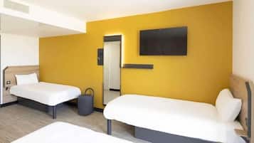 A hotel room with two beds, a flat-screen TV mounted on the wall, and a door leading to another room.