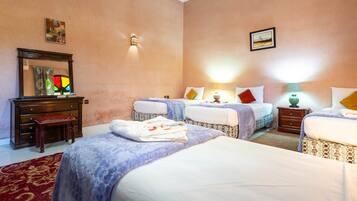 A hotel room with two beds, a dresser, a mirror, and a red carpet.