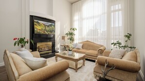A living room with a fireplace, sofas, and a coffee table.
