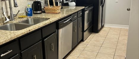 Enjoy cooking in this well-equipped kitchen with a microwave, refrigerator, and dishwasher.