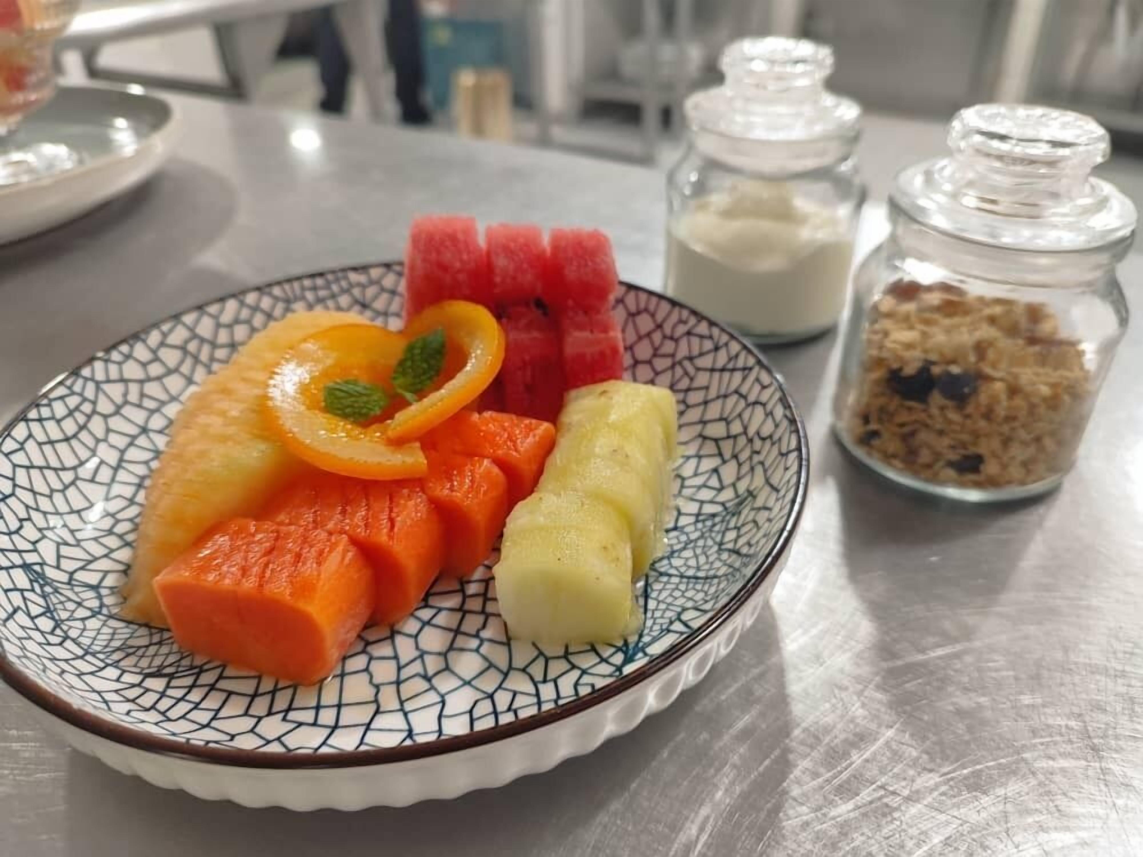 A plate of sliced fruits on a table.