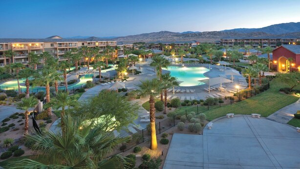 A resort with multiple swimming pools, palm trees, and a mountainous backdrop. - Indio Resort Condos by WorldMark (Indio)