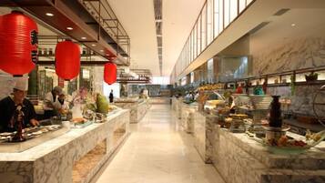 A hotel lobby with marble counters, red lanterns, and a long corridor.