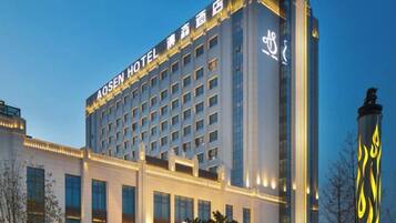 A multi-story hotel building with a prominent sign at the top.