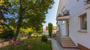 A residential building with a tiled pathway leading to a staircase.