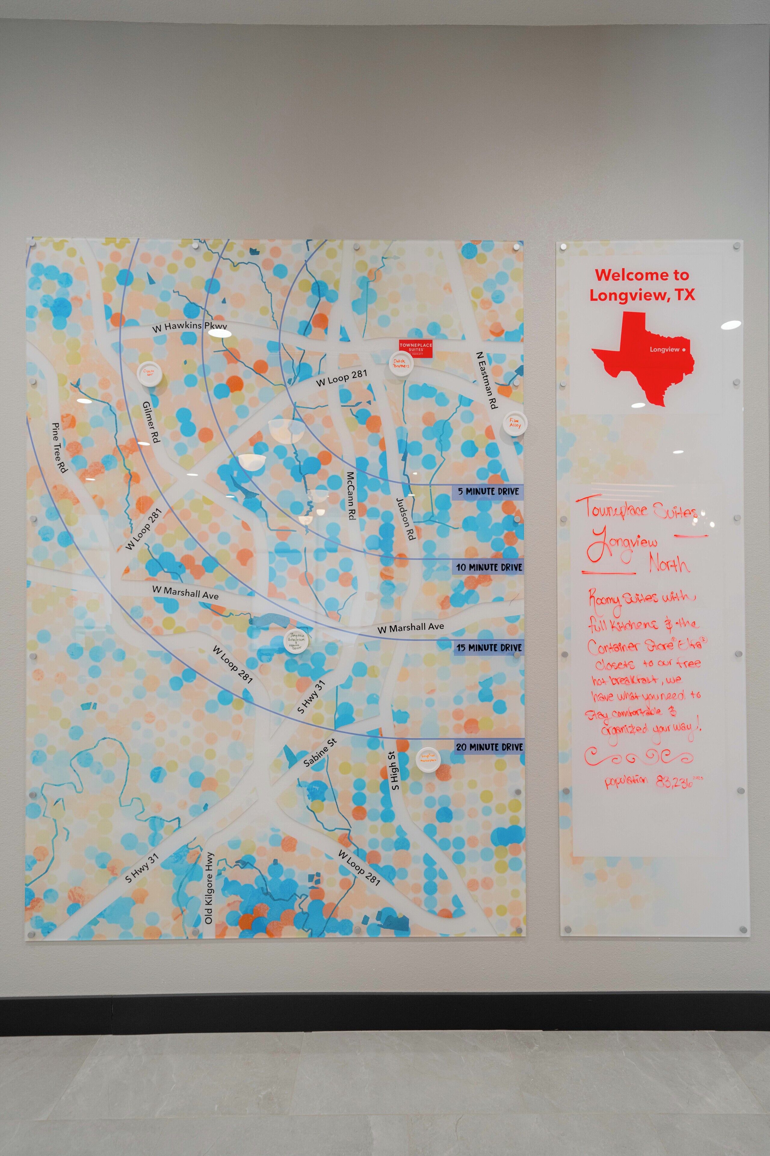 A map with location markers and a welcome sign for a hotel in Longview, TX.