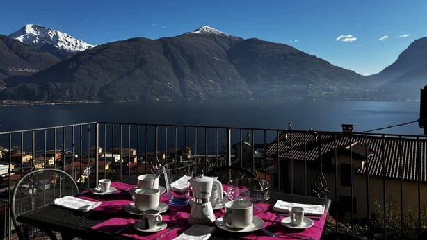 A table set for dining with a mountain view.