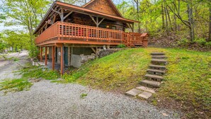 A rustic log cabin with a wooden deck and a stone staircase leading up to the entrance. - Keuka Lakefront | Dock w/ Boat Access | Kayak (Hammondsport)