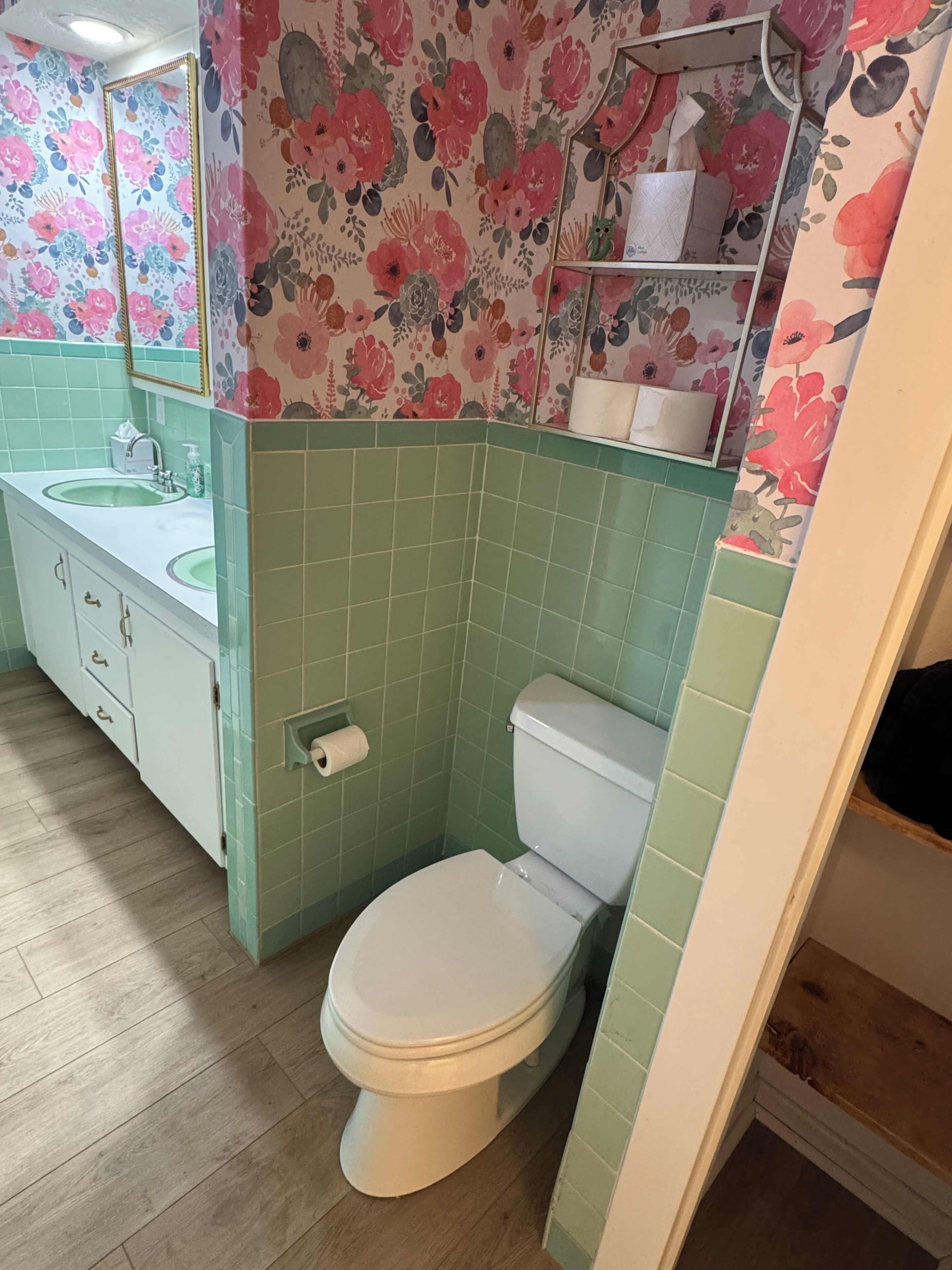 Un baño con inodoro, lavamanos y espejo.