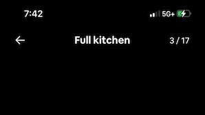 A modern kitchen with white cabinets, a gas stove, and a countertop with a knife block. - Spacious and Private (Bakersfield)