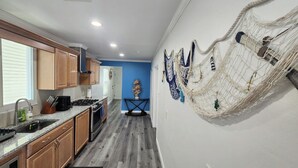 A kitchen with wooden cabinets, a granite countertop, and a built-in oven.