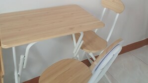 A small wooden table with a white chair and a round mirror on the wall. - Liebe stay (Busan)