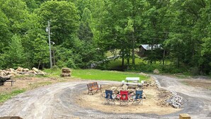 A view of a forested area with a dirt path leading to a clearing with a bench and chairs. - Clinch Mountain Reserve Cabin #2.  Cabin retreat near charming Rogersville, TN. (Rogersville)
