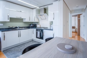 Fridge, oven, toaster, dining tables