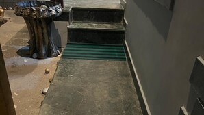 A narrow concrete pathway leading to a set of steps. - Al Mubeen (Srinagar)