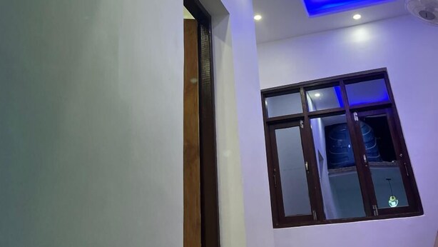 A room with a sloped ceiling, recessed lighting, and a window with a view of the outside. - Al Mubeen (Srinagar)