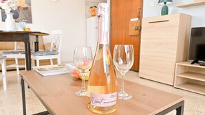 A bottle of Rosat Prosecco DOC Gavi on a wooden table with two empty wine glasses. - Sea Blue Horizon Qawra Bay 5, Qawra - Saint Paul's Bay, Malta (Qawra - Saint Paul's Bay)