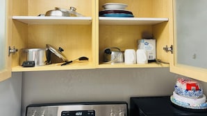 A kitchen with wooden cabinets, a toaster, a kettle, and a microwave. - Cozy Hideaway Parks + Trails Near SLC Airport (Lake Point)