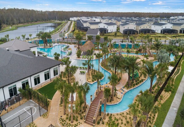 A residential area with multiple houses, a swimming pool, and a basketball court.