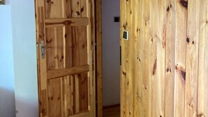 A wooden door with a simple design, a visible handle, and a small lock. - Gallys Mounting Cottage Pod Boubinem with WiFi (Lenora)