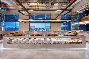 A modern kitchen with a central island, large windows, and a city view. - Crystal Hotel Beijing Anzhen (Beijing)