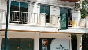 A two-story hotel with a sign advertising room for rent. - PLACE HOTEL (Karon)
