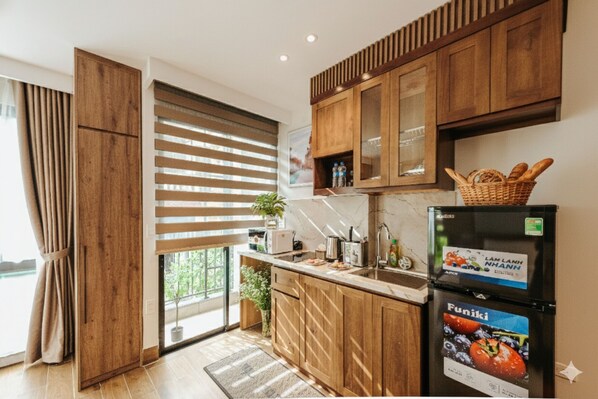 Una cocina moderna con armarios de madera, horno empotrado y refrigerador con etiqueta Funiki.