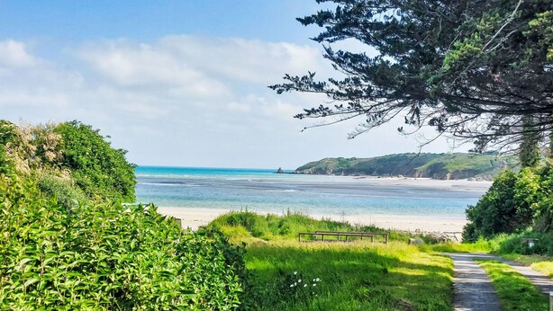 A coastal path leading to a beach with a clear view of the sea and distant land. - La Roche Blanche by Interhome (Hillion)