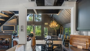 A modern kitchen with a built-in stove, a kettle, and a wooden countertop. - Custom Mountain Home · Hot Tub · Waterfall · 2.5 Acres · EV Charger (Placerville)