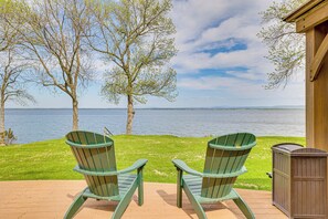 Two Adirondack chairs facing a lake with a wooden deck and a shed. - Lake Champlain Family Retreat w/ Deck & Yard (North Hero)