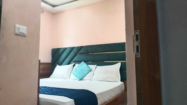 A bedroom with a bed, a ceiling fan, and a door.