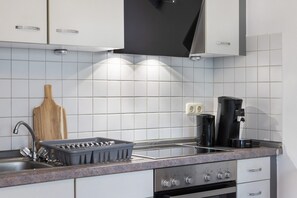 Fridge, microwave, coffee/tea maker, cookware/dishes/utensils