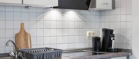 Fridge, microwave, coffee/tea maker, cookware/dishes/utensils