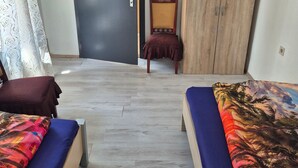 A room with two beds, a wardrobe, a door, and a chair. - Apartment 'Appartement Aurach A6' with Wi-Fi (Aurach)