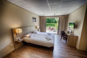 Relax in this stylish room with a large bed, two bedside tables, and a desk area.
