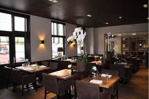 Enjoy a sophisticated dining experience with elegant table settings and refined decor.