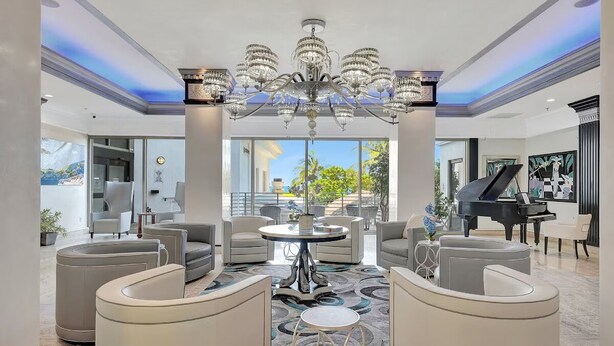 A spacious lobby with a grand chandelier, comfortable seating, and a grand piano. - Tropical Retreat with Pool, Spa & Resort-Style Amenities (Fort Lauderdale)