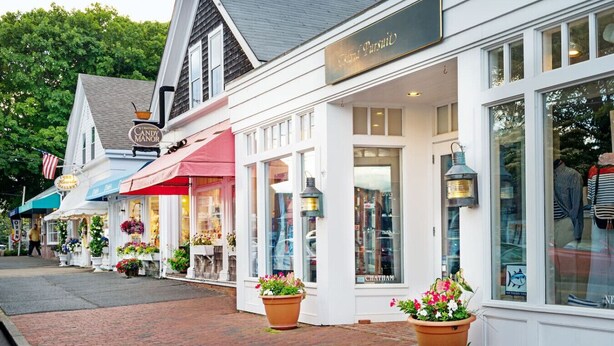 A row of white buildings with storefronts, including a visible sign for 'Chatham' and a 'Chatham' sign above a window.