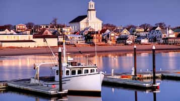 Overlooking the calm water, this serene waterfront scene features a picturesque church and charming homes.