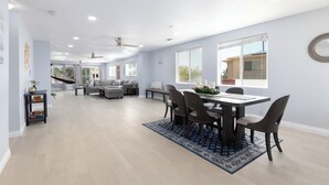 Un salón espacioso con una mesa de comedor, sillas y un sofá.