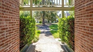 A pathway leading to a gated area with a wooden fence and a brick wall on either side. - Napa Valley Getaway in Silverado (Napa)
