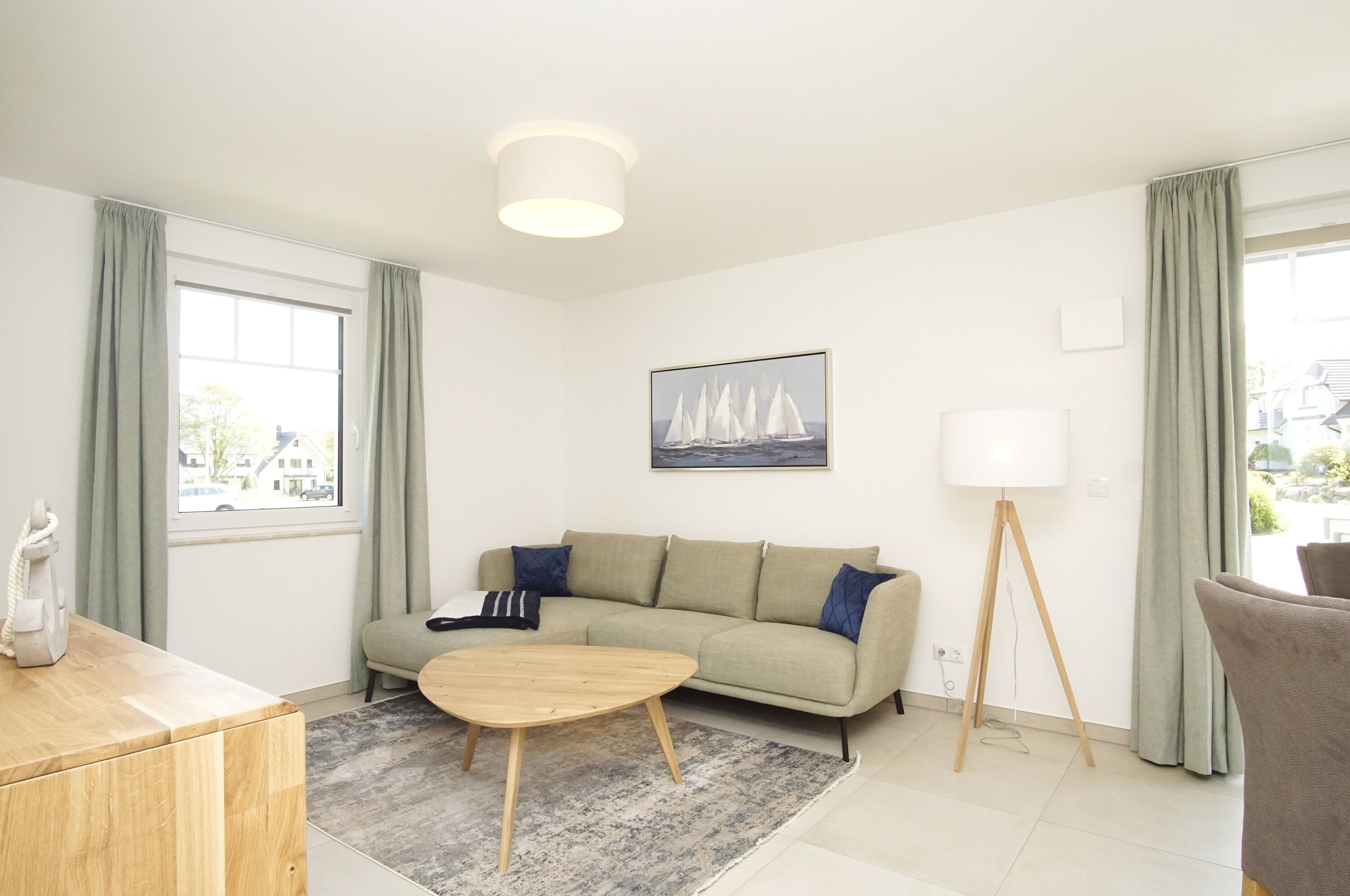 A modern living room with a sofa, coffee table, and a lamp.