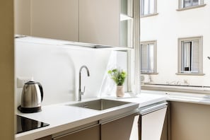 Apartment, Balcony | Private kitchen | Coffee/tea maker, electric kettle, dining tables