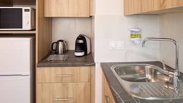 Apartment | Private kitchen | Microwave, stovetop, cookware/dishes/utensils, dining tables
