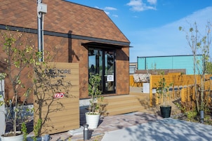 A building with a tiled roof, a wooden entrance, and a sign that reads "LECTORE".