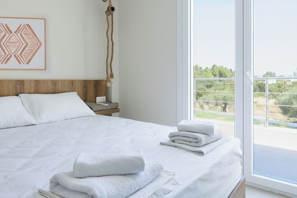 Elegant Bedroom with Private Balcony & Olive Grove Views